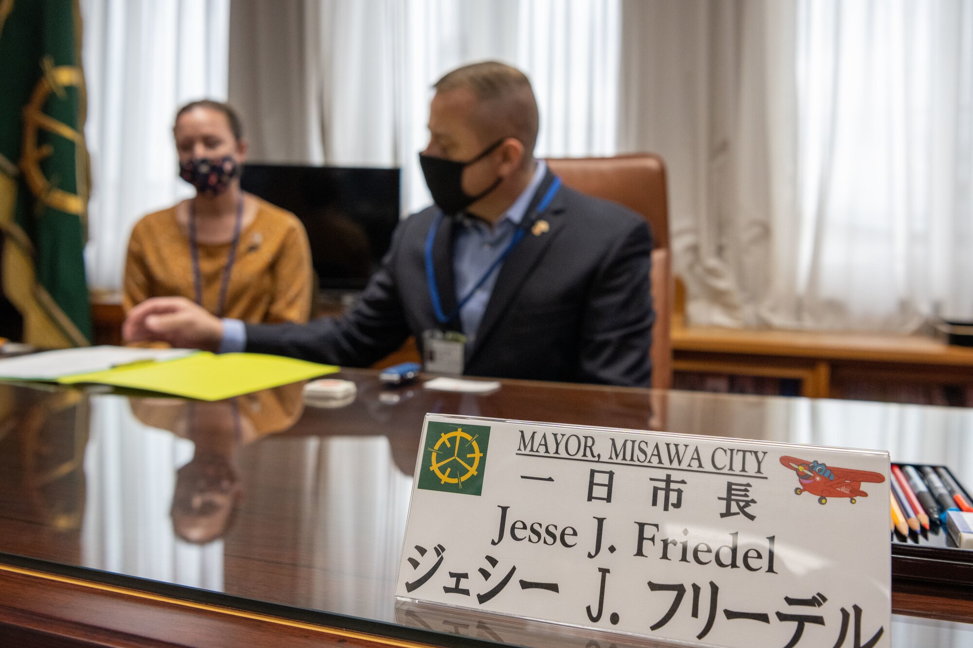 A military member looks at a document at the table.
