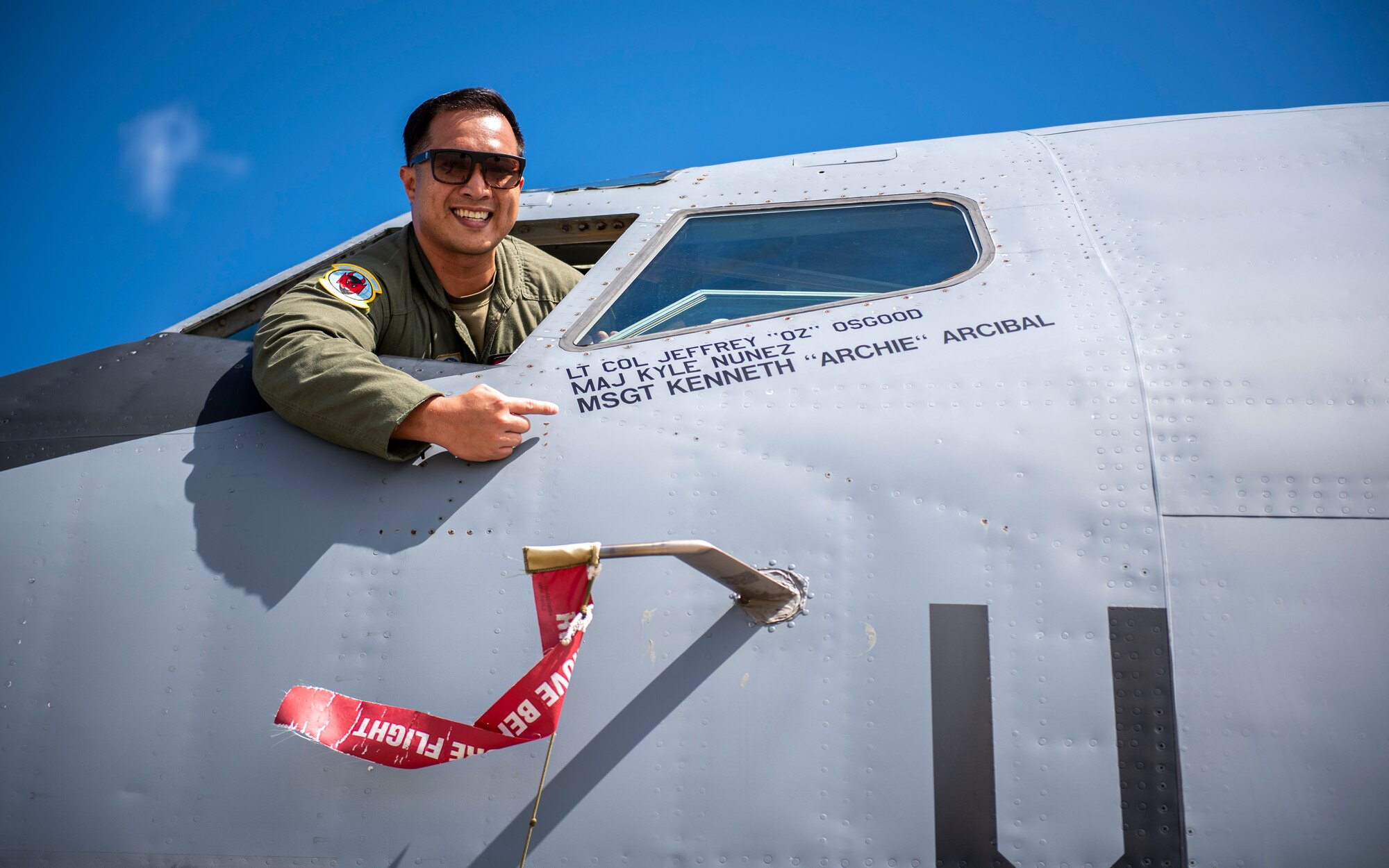 U.S. Air Force Master Sgt. Kenneth Arcibal, a boom operator assigned to the 50th Air Refueling Squadron, points to his name on a KC-135 Stratotanker at MacDill Air Force Base, Florida, June 1, 2022. The aircraft was retired and flown to Sheppard AFB, Texas, to be used as a training tool for future maintainers. (U.S. Air Force photo by Airman 1st Class Lauren Cobin)