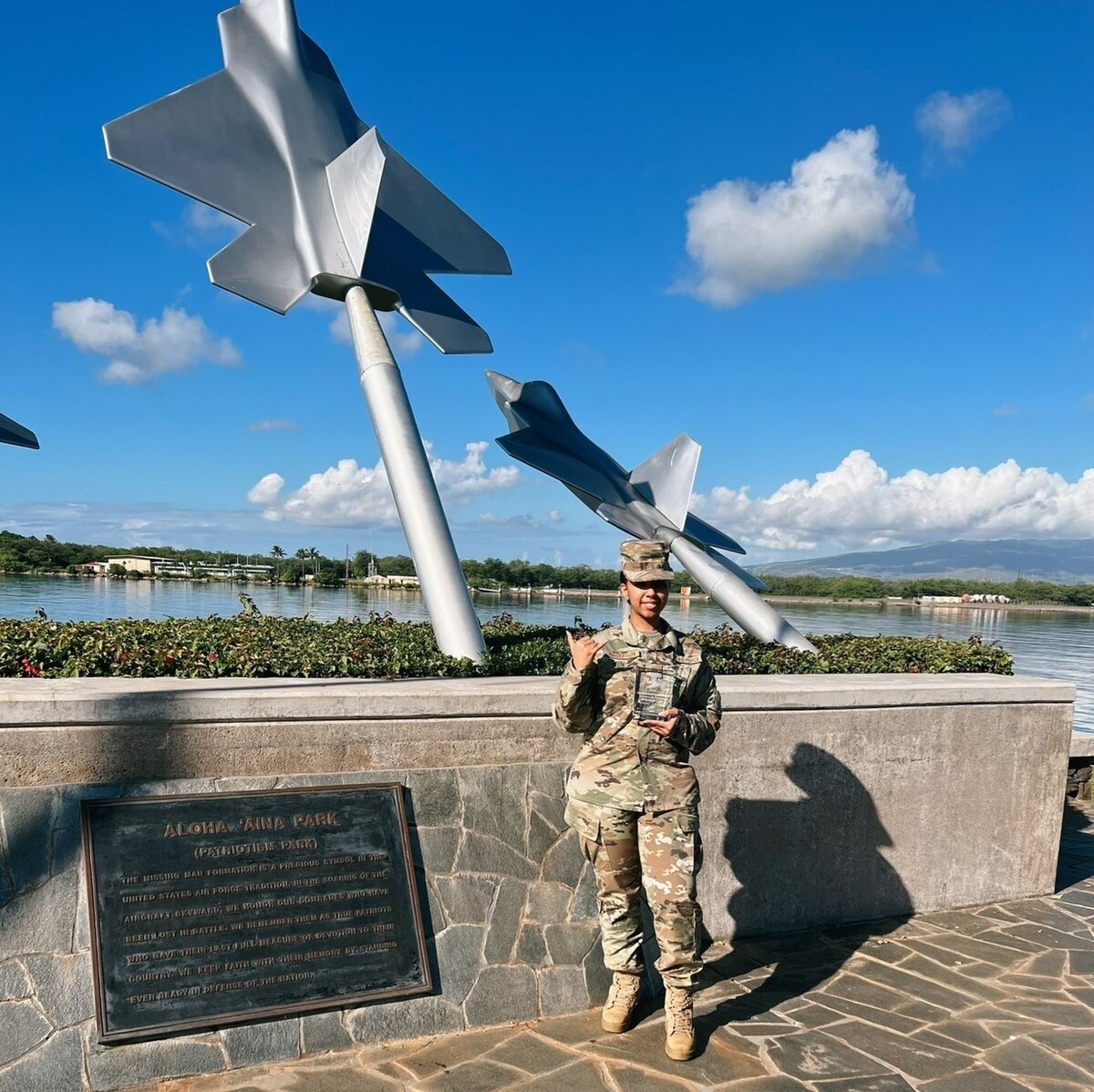 Senior Airman Anderson stands in front of Air Force sculpture in Hawaii.
