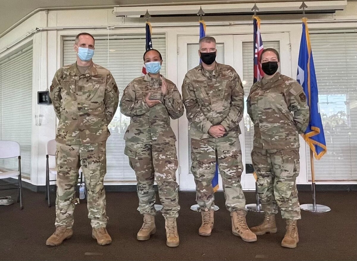 Senior Airman Anderson holds her Quarterly Award and stands with Maj. Gen. Jeffrey T. Pennington, Fourth Air Force commander; Col. Joseph Orcutt, 624 RSG commander; and Chief Master Sgt. Andrea Young, senior enlisted leader.