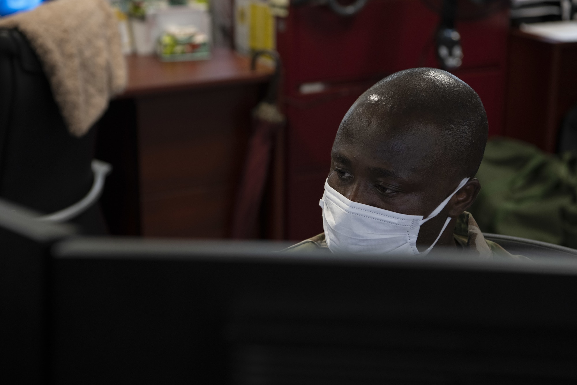 U.S. Air Force Staff Sgt. Emmanuel Agyemang Duah, 18th Comptroller Squadron travel team lead, works in the 18th CPTS financial analysis office at Kadena Air Base, Japan, May 17, 2022. The financial management office won the FY 2021 PACAF FMA of the year award. (U.S. Air Force photo by Staff Sgt. Rhett Isbell)