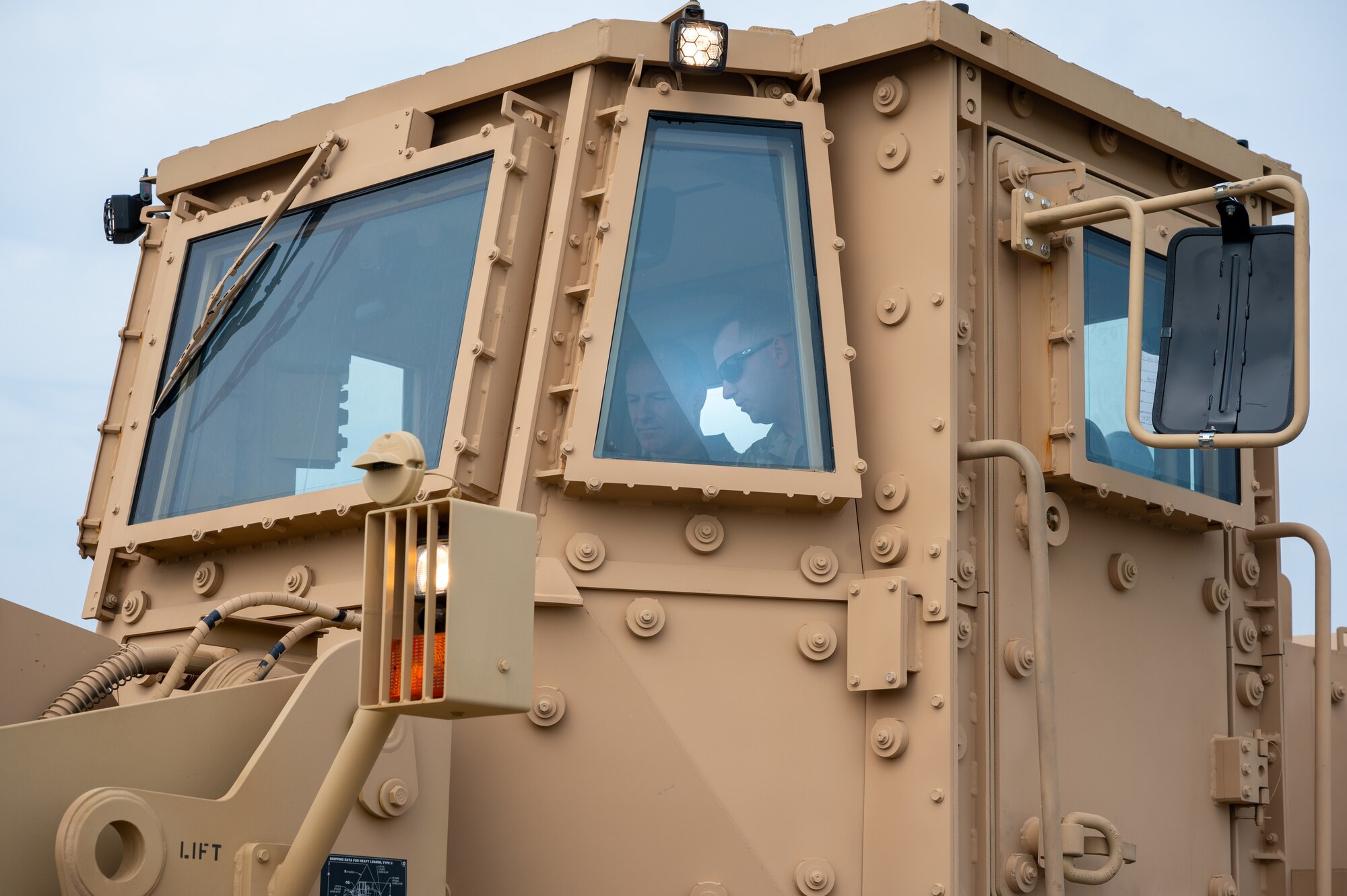 Lt. Gen. Scott Pleus, Seventh Air Force commander, sits in a up-armored loader
