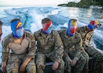 Blindfolded competitors are taken on a boat to an island during the Region VII Best Warrior Competition on Guam May 26, 2022. The annual competition featured the best noncommissioned officer and Soldier from Arizona, California, Colorado, Guam, Hawaii, Nevada, New Mexico and Utah. The winners move on to the national competition in July.