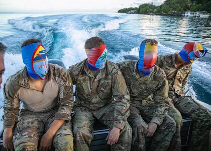 Blindfolded competitors are taken on a boat to an island during the Region VII Best Warrior Competition on Guam May 26, 2022. The annual competition featured the best noncommissioned officer and Soldier from Arizona, California, Colorado, Guam, Hawaii, Nevada, New Mexico and Utah. The winners move on to the national competition in July.