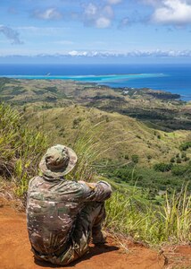 U.S. Army Cpl. Spencer Fayles with the 144th Area Support Medical Company, Utah National Guard, remains in good spirits on a nearly six-mile ruck march as part of the mystery event during the Region VII Best Warrior Competition on the island of Guam May 26, 2022.