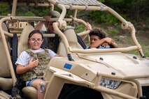Children sitting in all-terrain vehicle