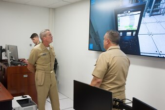 DAHLGREN, Va. (June 01, 2022) Capt. Russ Sanchez, commanding officer, discusses the schoolhouse’s Virtual Maintenance Trainer (VMT), a high-fidelity 3D gaming environment that provides a virtual depiction of the Aegis Weapon System computer network, to Rear Adm. Pete Garvin, commander, Naval Education and Training Command (NETC), during his visit to Surface Combat Systems Training Command (SCSTC) AEGIS Training and Readiness Center (ATRC) onboard Naval Support Facility (NSF) Dahlgren. The VMT was funded by Director, Surface Warfare’s (OPNAV N96) program of record, Surface Training Advanced Virtual Environment-Combat Systems (STAVE-CS), which was introduced in 2015 as a means to provide better quality training resulting in more rapid qualifications of our Sailors.  (U.S. Navy photo by Michael Bova)