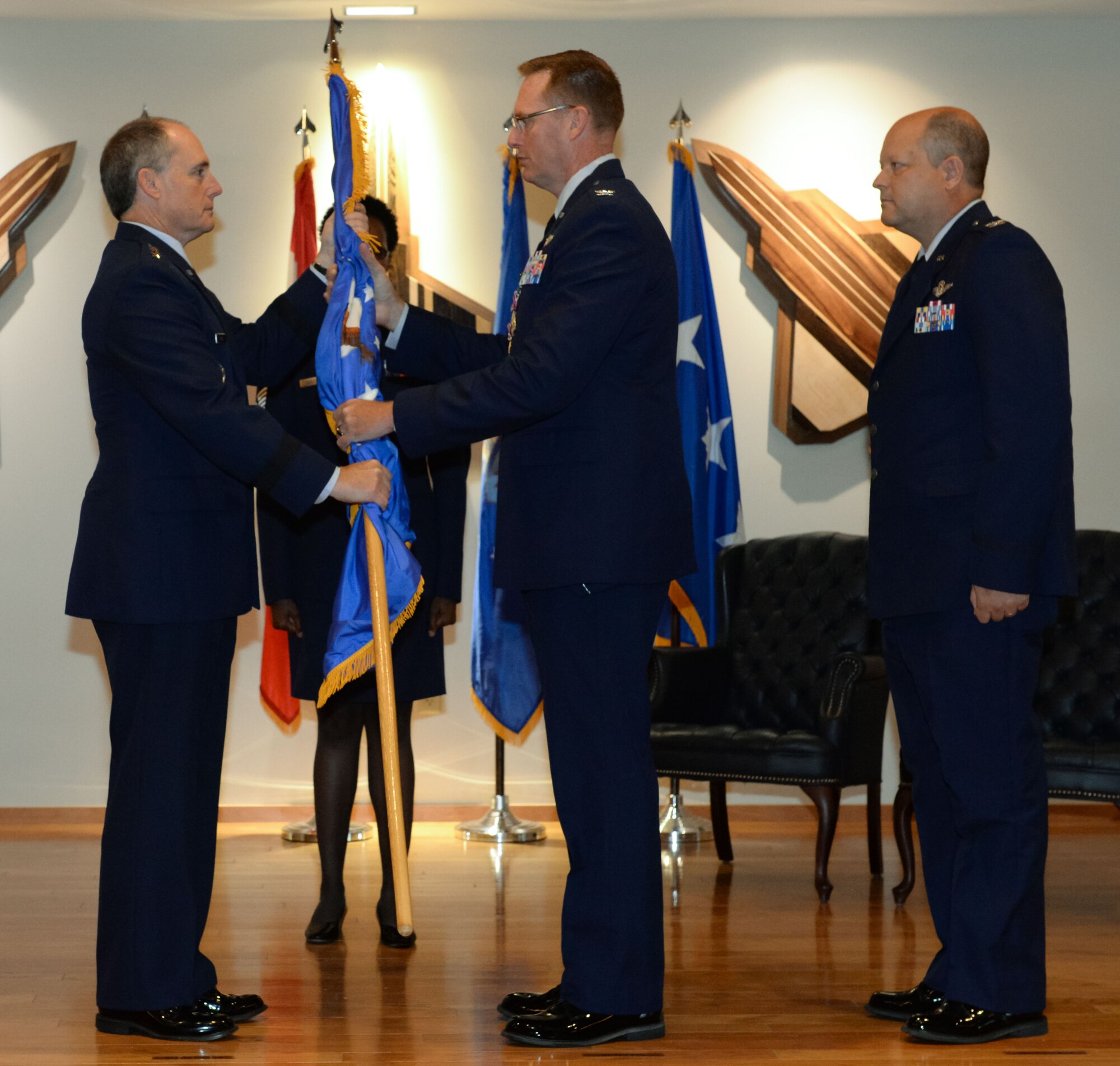 Col. Gregory Krane, former 601st Air Operations Center commander, passes the ceremonial flag to Lt. Gen. Kirk Pierce, Continental U.S. North American Aerospace Defense Command Region – 1st Air Force (Air Forces Northern and Air Forces Space) commander, during the 601st AOC change of command ceremony at Tyndall Air Force Base, Florida on June 1, 2022.  The passing of the flag symbolizes Krane's passing of command to Col. Clayton Schaefer, the new commander of the 601st AOC. (Air National Guard photo by Master Sgt. Regina Young)