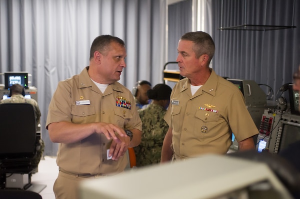 DAHLGREN, Va. (June 01, 2022) Capt. Russ Sanchez, commanding officer, shows the schoolhouse’s Baseline 5.4 Combat Information Center lab to Rear Adm. Pete Garvin, commander, Naval Education and Training Command (NETC), during his visit to Surface Combat Systems Training Command (SCSTC) AEGIS Training and Readiness Center (ATRC) onboard Naval Support Facility (NSF) Dahlgren. (U.S. Navy photo by Michael Bova)