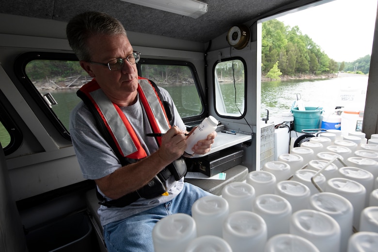 Mark Campbell, hydrologist in the U.S. Army Corps of Engineers Nashville District’s Water Management Section, prepares plastic bottles for sampling during a water quality survey mission on Lake Cumberland in Kentucky May 25, 2022. (USACE Photo by Lee Roberts)