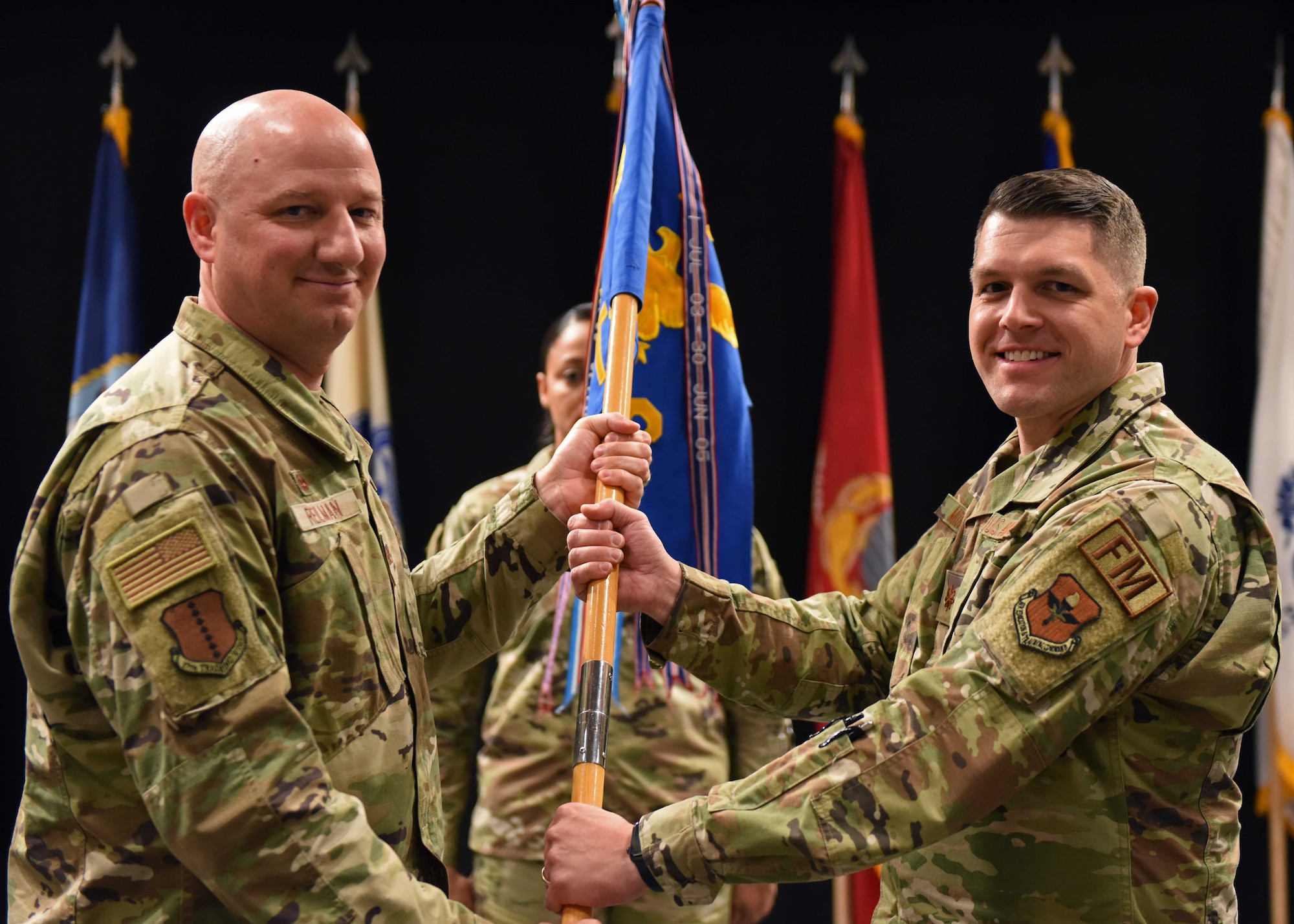 U.S. Air Force Maj. Justin Moore, 17th Comptroller Squadron incoming commander, (right) assumes command from Col. Matthew Reilman, 17th Training Wing commander, during the 17th CPTS change of command ceremony at the Powell Event Center, June 3, 2022. Change of commands are a military tradition representing the transfer of responsibilities from the presiding official to the incoming official. (U.S. Air Force photo by Airman 1st Class Sarah Williams)