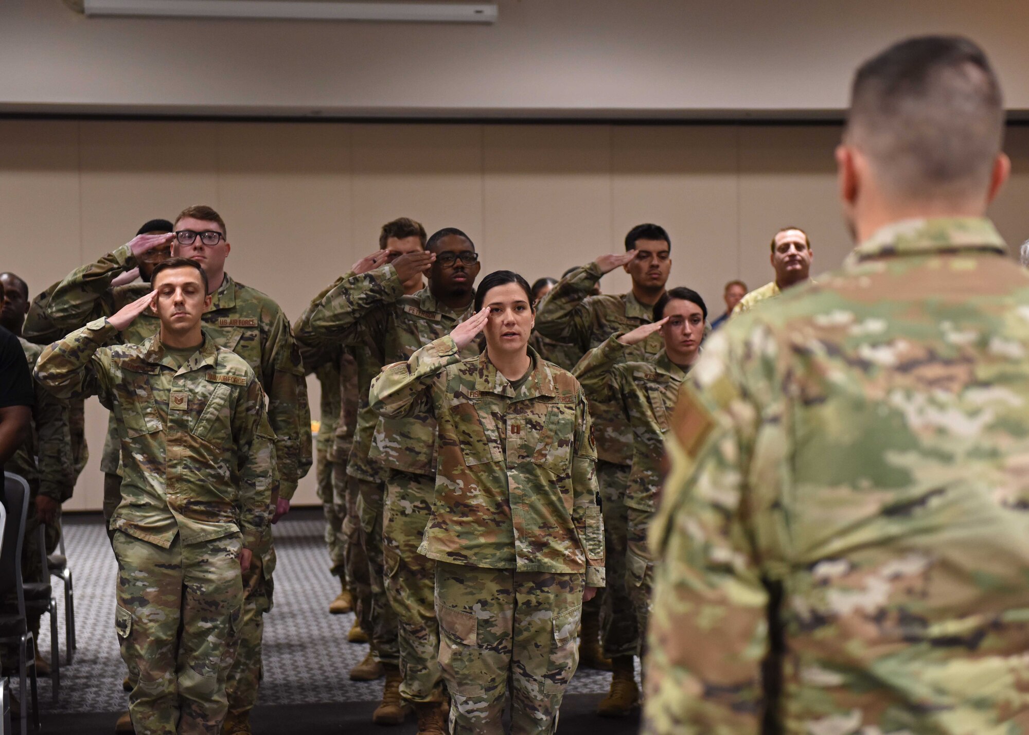 Members of the 17th Training Wing Wing Staff Agencies salute U.S. Air Force Maj. Justin Moore, 17th CPTS incoming commander, at the 17th CPTS change of command ceremony at the Powell Event Center, June 3, 2022. Moore previously served as the Senior Economist for Deputy Assistant Secretary for Cost and Economics, Office of the Assistant Secretary of the Air Force for Financial Management and Comptroller, Pentagon, Washington, D.C. (U.S. Air Force photo by Airman 1st Class Sarah Williams)