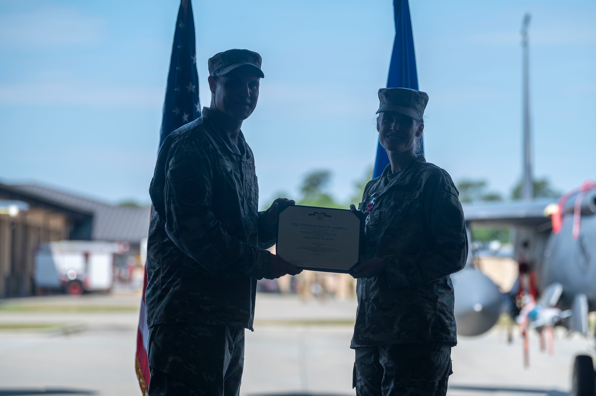 Col. Lucas Teel, 4th Fighter Wing commander, presents the Legion of Merit award to Col. Leah Fry, outgoing 4th Maintenance Group commander, before she relinquishes command at Seymour Johnson Air Force Base, North Carolina, June 3, 2022. The Legion of Merit is given for exceptionally meritorious conduct in the performance of outstanding services and achievement. (U.S. Air Force photo by Senior Airman Kevin Holloway)