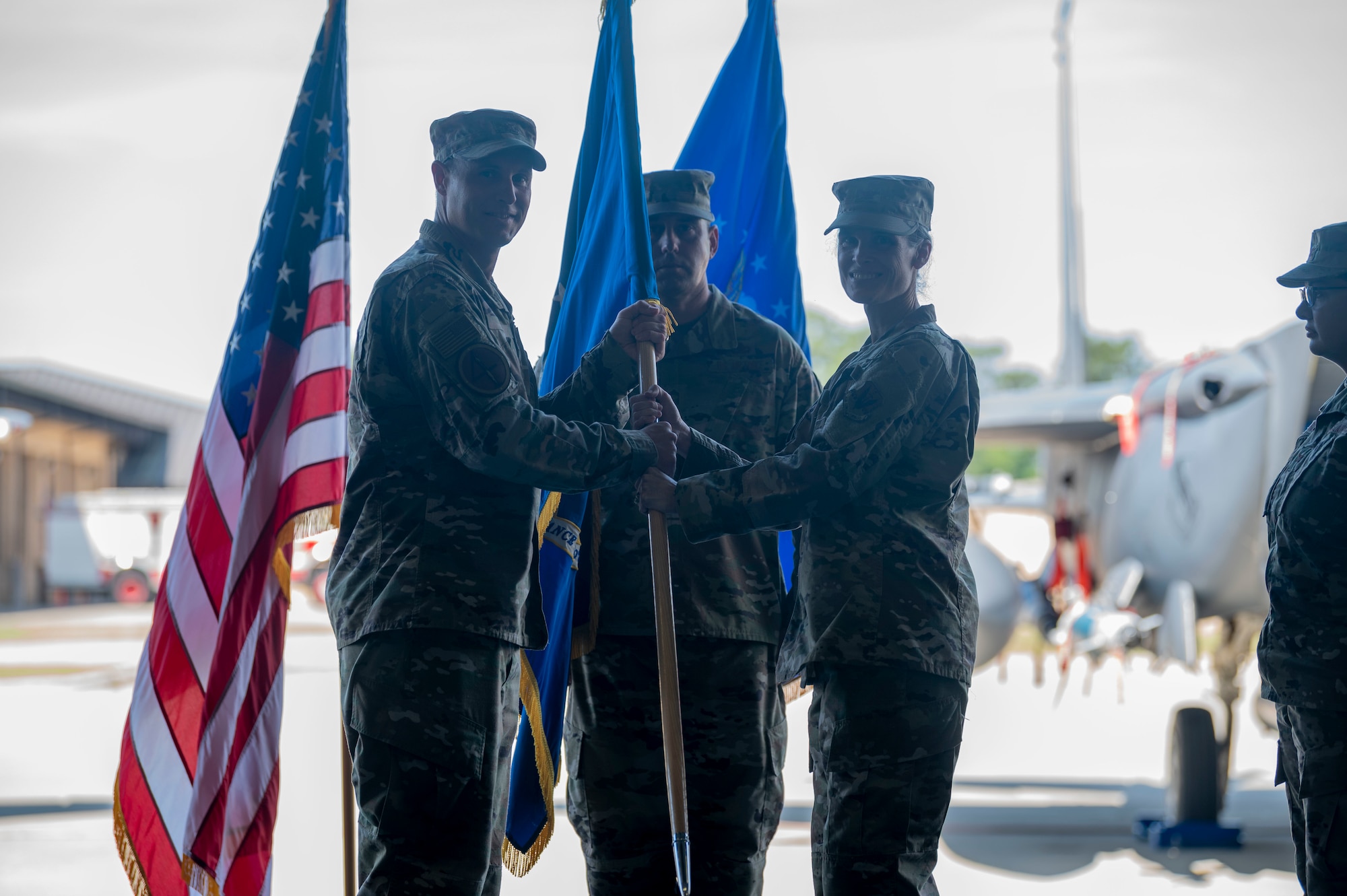 Col. Leah Fry, 4th Maintenance Group commander, passes the guidon to Col. Lucan Teel, 4th Fighter Wing commander, while relinquishing command during a change of command ceremony at Seymour Johnson Air Force Base, North Carolina, June 3, 2022. The passing of a unit’s guidon symbolizes the transfer of command. (U.S. Air Force photo by Senior Airman Kevin Holloway)
