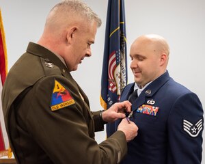 U.S. Army Maj. Gen. Michael J. Turley, the Adjutant General of the Utah National Guard, presents U.S. Air Force Staff Sgt. Jacob A. Hardwick, the material controller for the 109th Air Control Squadron, the Purple Heart for wounds received in action, in a ceremony on April, 9, 2022 at Rowland R. Wright Air National Guard Base, Salt Lake City. The Purple Heart is known as the nation's oldest military award. (U.S. Air Force photo by Tech Sgt. Danny Whitlock)