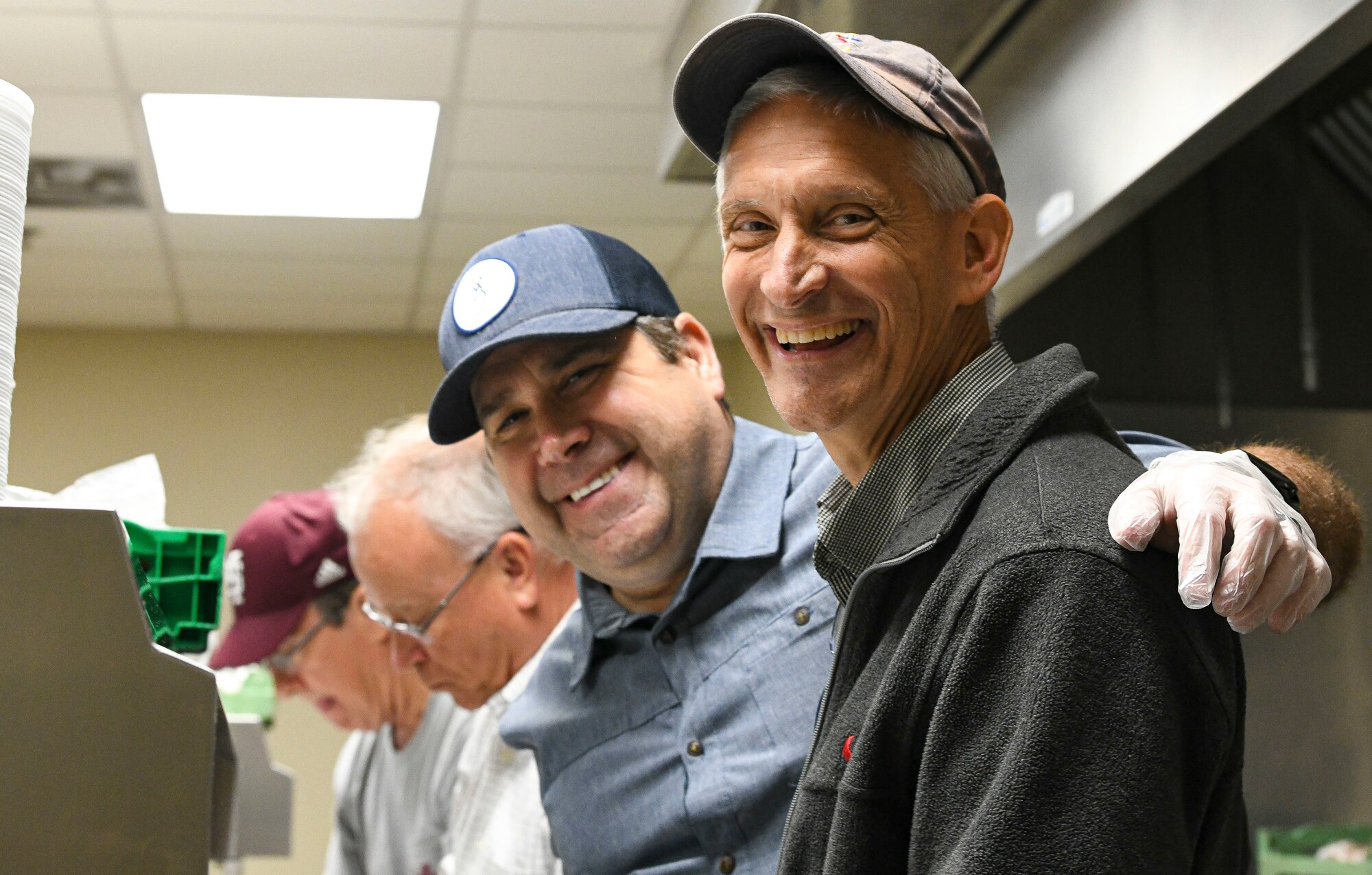 Former and present commanders and command chief master sergeants of the 172nd Airlift Wing gathered to serve lunch to Airmen and full-time staff at the Wing’s dining facility on April 6, 2022. (U.S. Air National Guard photo by 1st Lt. Kiara Spann)