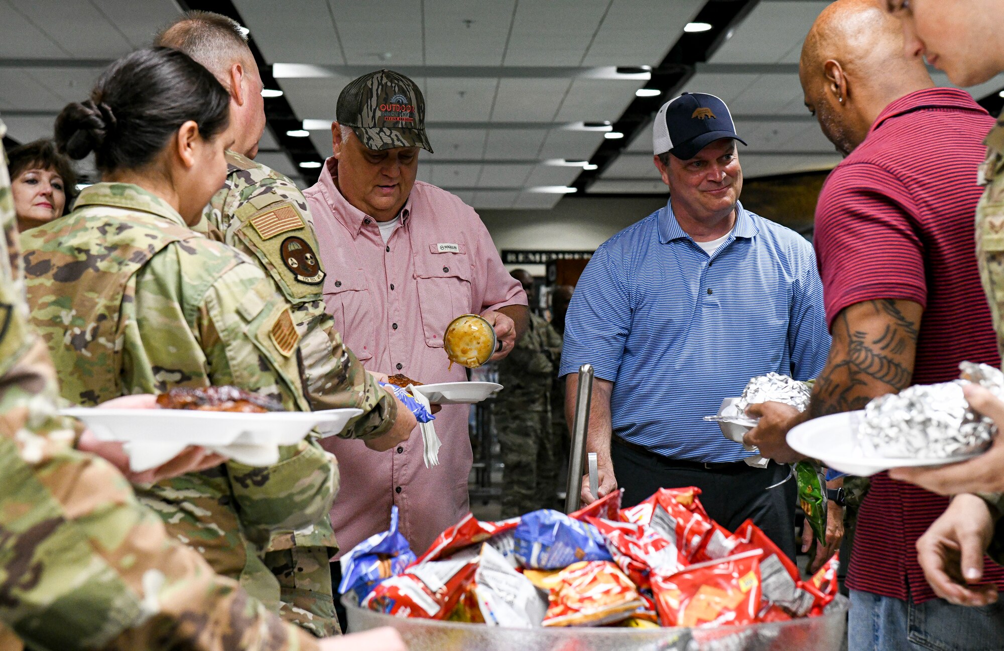 Former and present commanders and command chief master sergeants of the 172nd Airlift Wing gathered to serve lunch to Airmen and full-time staff at the Wing’s dining facility on April 6, 2022. (U.S. Air National Guard photo by 1st Lt. Kiara Spann)