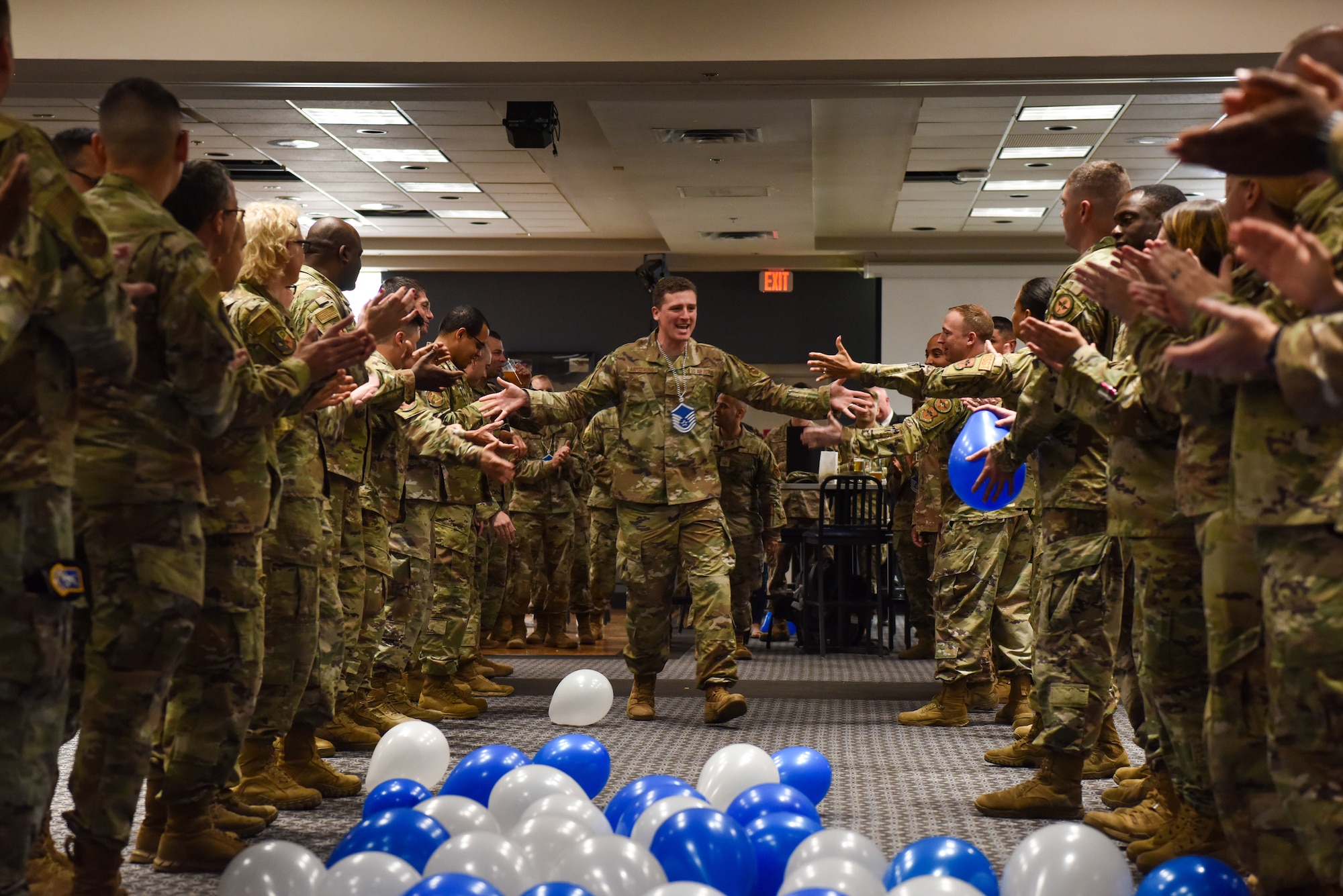 U.S. Air Force Master Sgt. select Christopher Armstrong, 313th Training Support Squadron course chief, runs through a crowd of supporters during a master sergeant release party at the Powell Event Center, Goodfellow Air Force Base, Texas, June 2, 2022. Coworkers and family members congratulated selectees before they received their certificates. (U.S. Air Force photo by Staff Sgt. Jermaine Ayers)