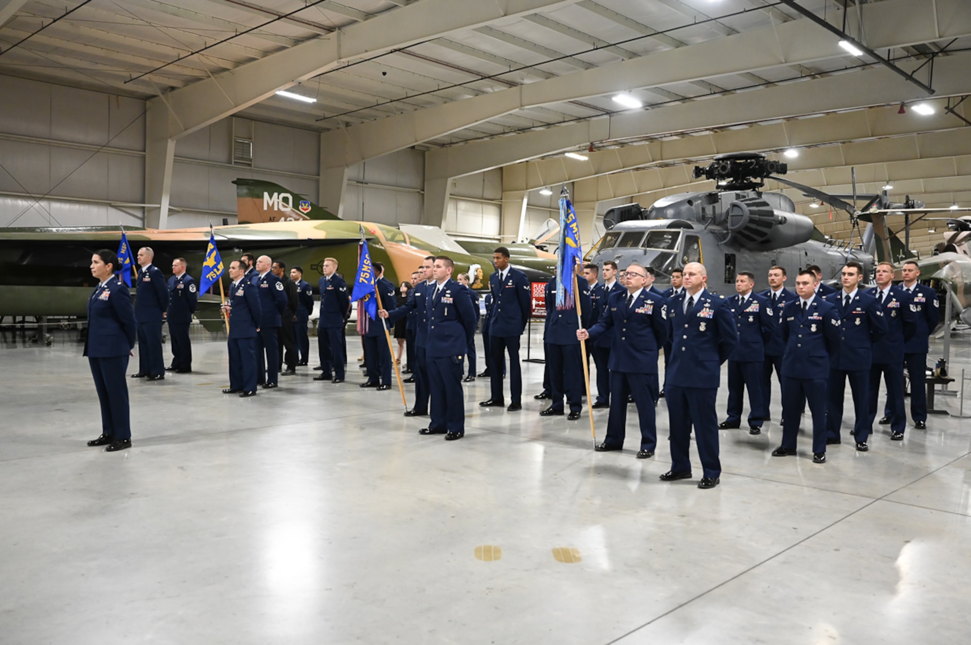 Four squadrons that make up the 75th Mission Support Group stand at parade rest during the change of command ceremony.