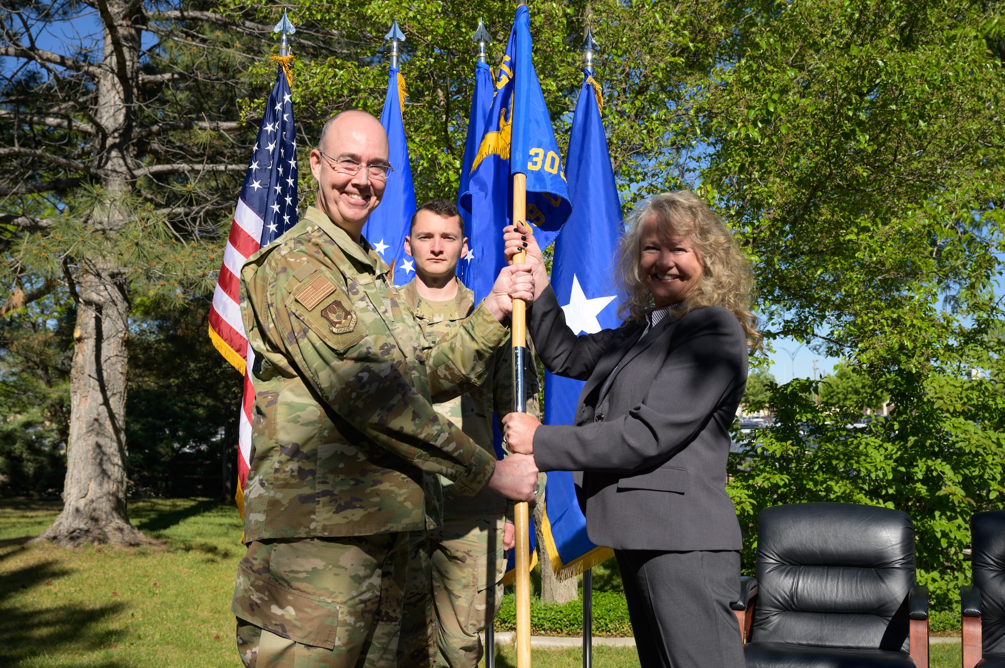 Right, Sandy Fitzgerald, incoming 309th Commodities Maintenance Group director, receives the guidon from Brig. Gen. Richard Gibbs, Ogden Air Logistics Complex commander, during an appointment to leadership ceremony at Hill Air Force Base, Utah, June 2, 2022. The 309th CMXG is the technical repair center for landing gear, wheels, brakes, secondary power systems, hydraulics and composites. (U.S. Air Force photo by R. Nial Bradshaw)
