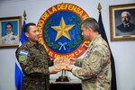 Sargento Mayor Demar Garcia of the Salvadoran army presents NH Adjutant. Gen. David Mikolaities a plaque of El Salvador's national bird, the turquoise-browed motmot, during a gift exchange May 25, 2022,at the Ministry of Defense in San Salvador, El Salvador.