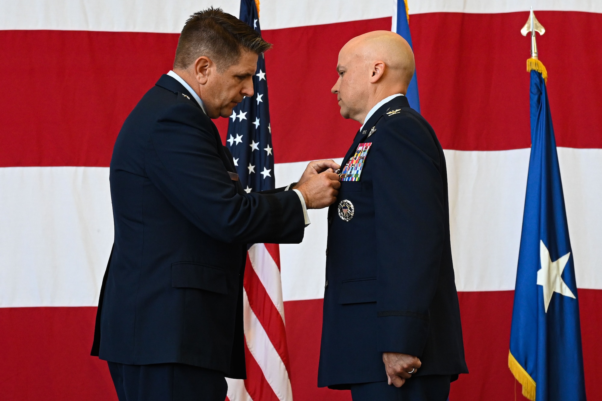 Brig. Gen. Christopher Amrhein, 19th Air Force vice commander, presents the Legion of Merit Medal to Col. Joseph Miller, former 314th Airlift Wing commander, during a change of command ceremony