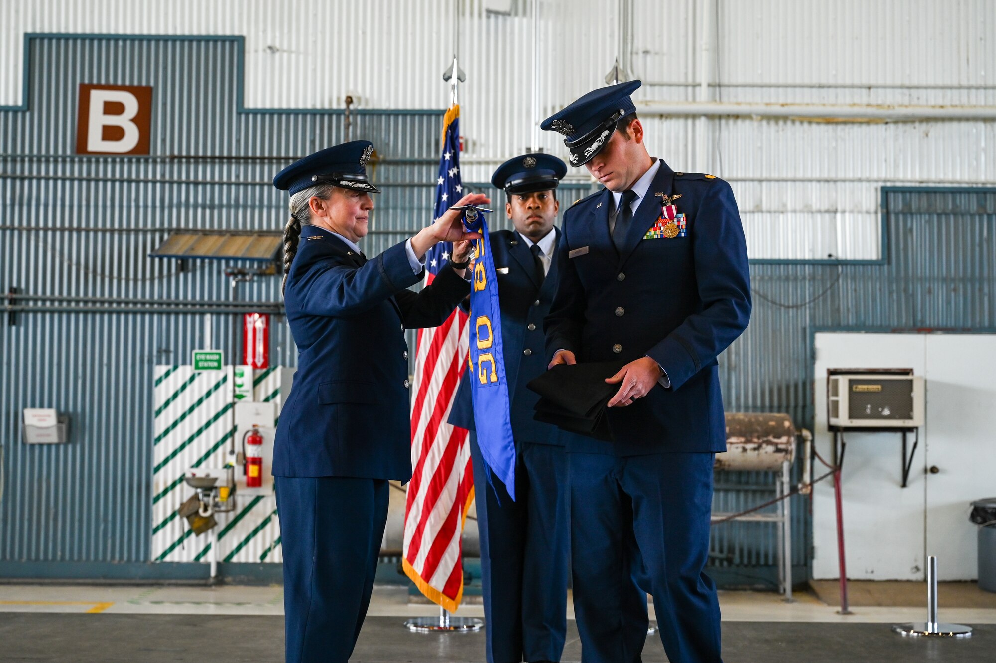 Airmen adjust guidon.