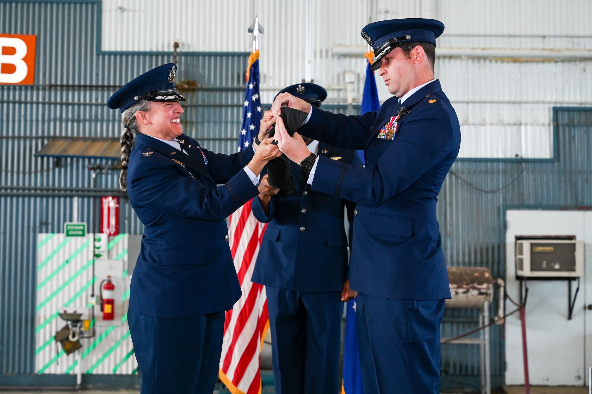 Airmen adjust guidon.