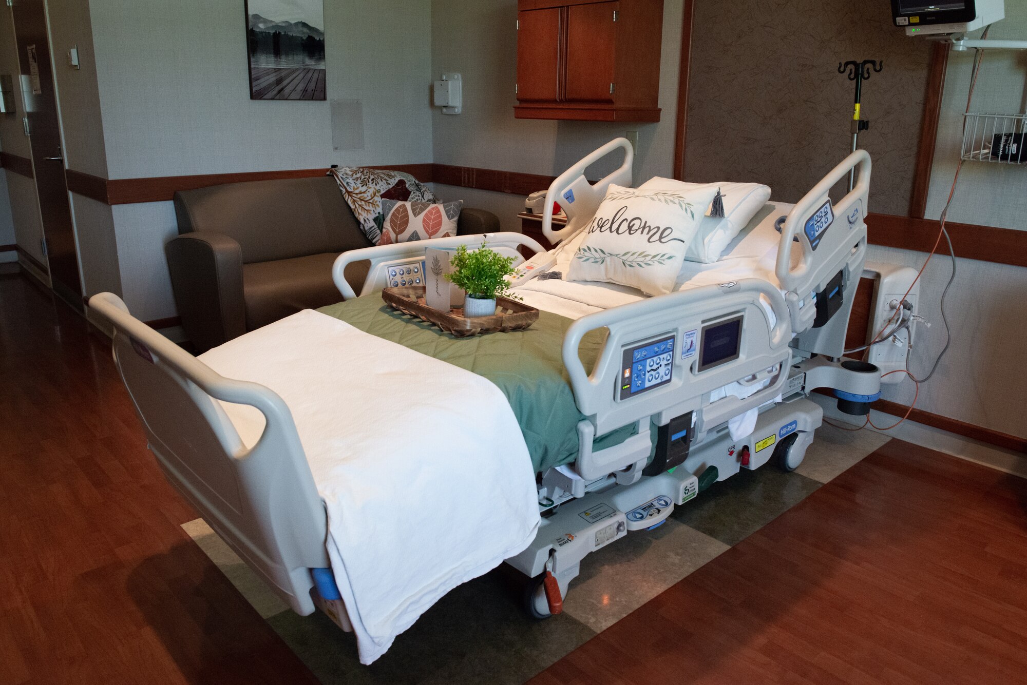 A hospital room furnished with decorative items and a personalized bed