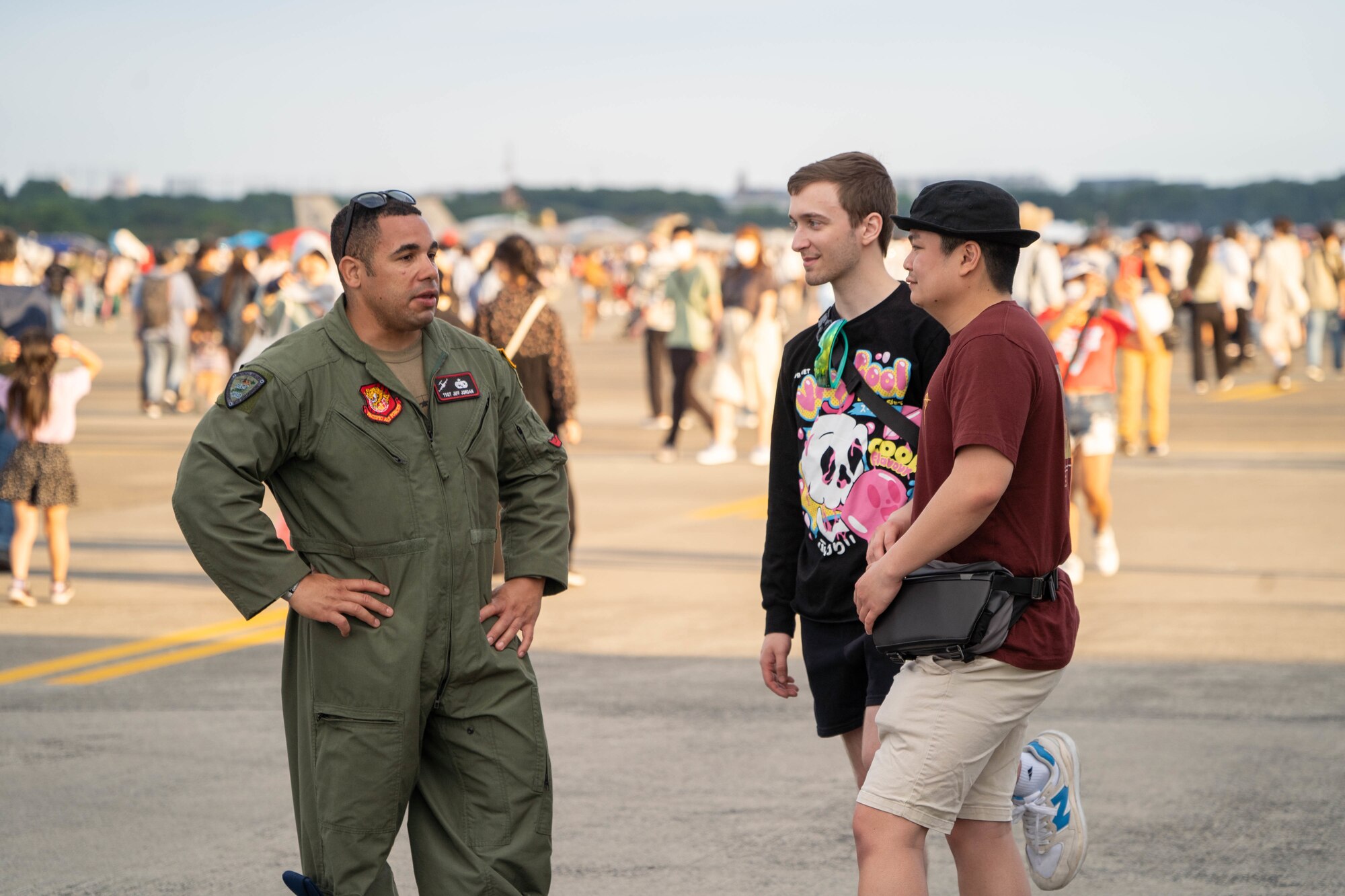 Tech Sgt. Jeff Jordan, 15th Aircraft Maintenance Squadron crew chief, interacts with festival visitors during the Friendship Festival 2022 at Yokota Air Base, Japan, May 22, 2022. The festival was an opportunity for visitors to learn and celebrate the partnership between the U.S. and Japan, while strengthening the bonds between Yokota and the local communities. (U.S. Air Force photo by Airman 1st Class Makensie Cooper)