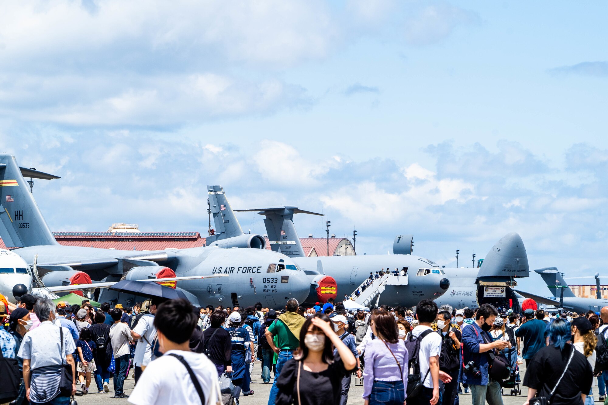 Festival guests walk around the flightline interacting with airmen and touring static displays during the Friendship Festival 2022 at Yokota Air Base, Japan, May 22, 2022. The event embodied the true spirit of friendship, welcoming more than 110,000 Japanese neighbors, sharing our cultures through food, music, and performances. (U.S. Air Force photo by Airman 1st Class Makensie Cooper)