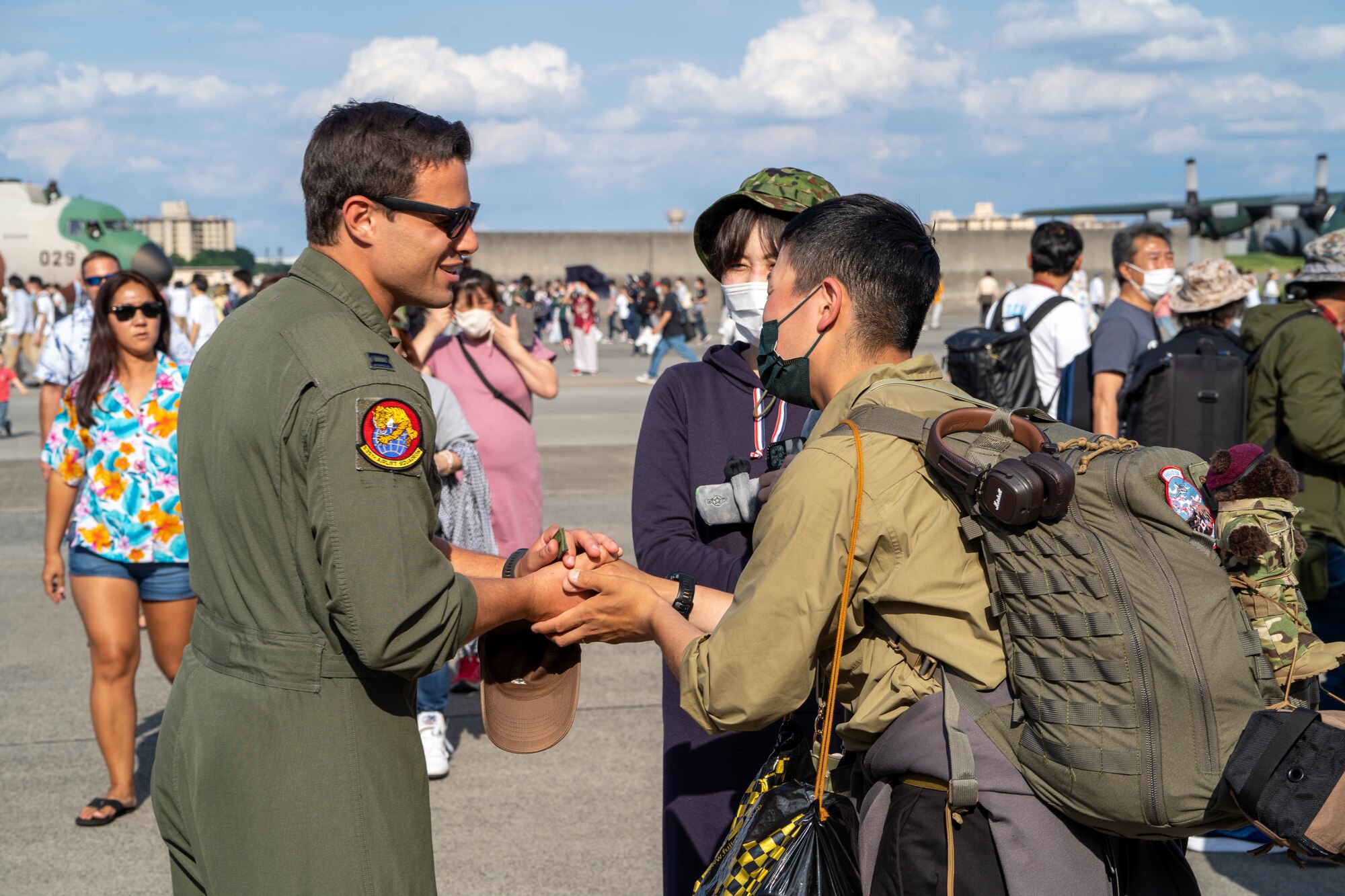 Capt. Logan Hawke, 535th Airlift Squadron pilot, interacts with guests at the Friendship Festival 2022 at Yokota Air Base, Japan, May 22, 2022. The festival was an opportunity to learn about and celebrate the enduring partnership between the U.S. and Japan. (U.S. Air Force photo by Airman 1st Class Makensie Cooper)