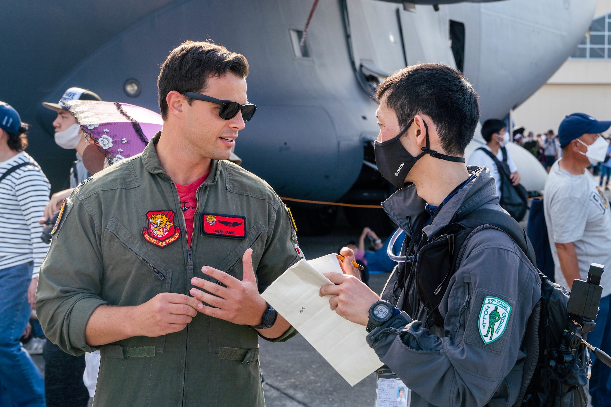 Capt. Logan Hawke, 535th Airlift Squadron pilot, interacts with guests at the Friendship Festival 2022 at Yokota Air Base, Japan, May 22, 2022. The festival was an opportunity to learn about and celebrate the enduring partnership between the U.S. and Japan. (U.S. Air Force photo by Airman 1st Class Makensie Cooper)