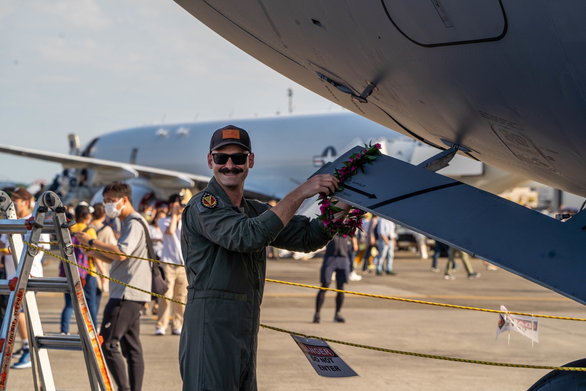 Capt. Sherman Williams, 19th Fighter Squadron pilot hangs a lei made by a festival guest during the Friendship Festival 2022 at Yokota Air Base, Japan, May 22, 2022. The festival was an opportunity for visitors to learn and celebrate the partnership between the U.S. and Japan, while strengthening the bonds between Yokota and the local communities. (U.S. Air Force photo by Airman 1st Class Makensie Cooper)