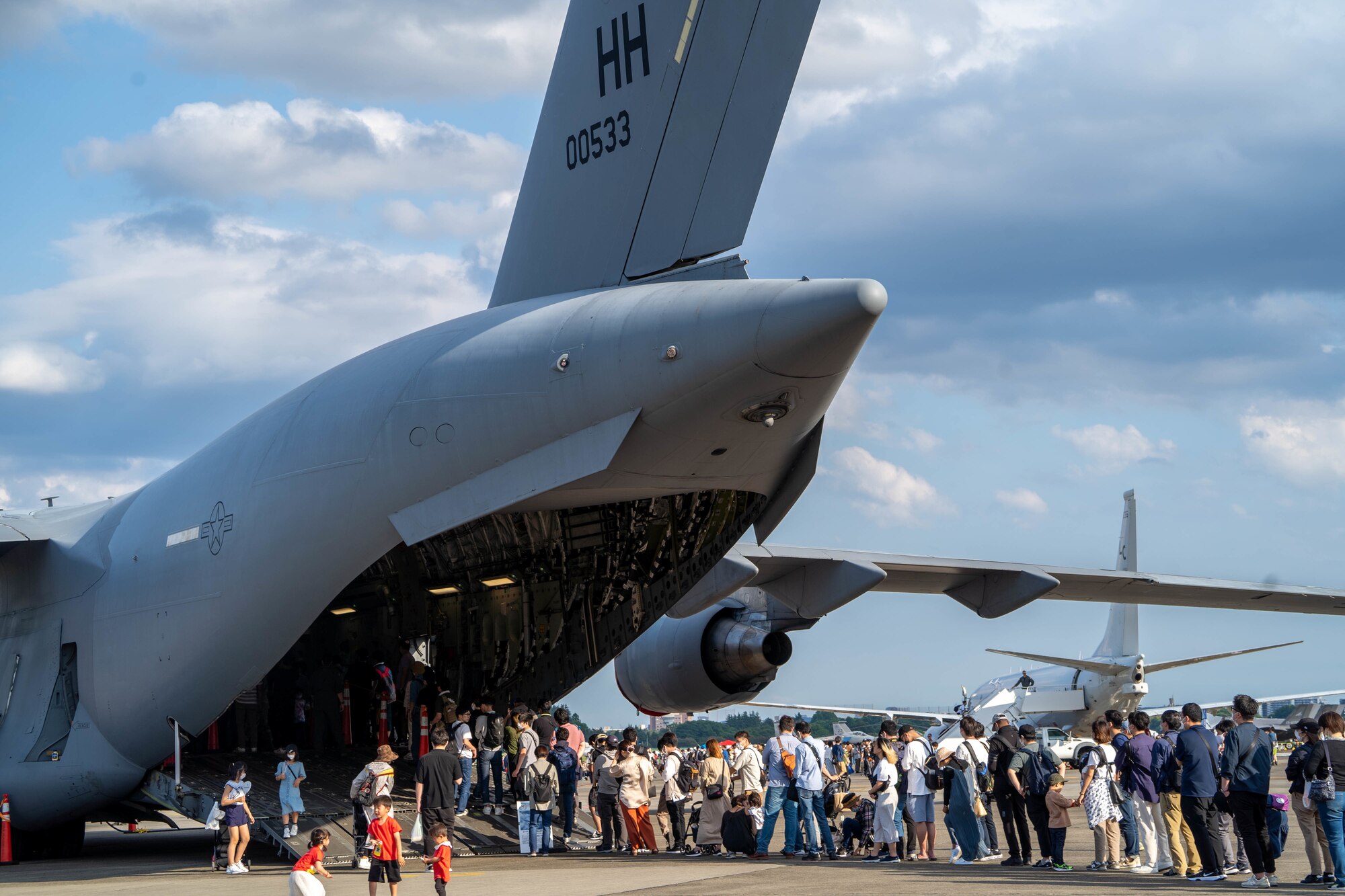 Festival visitors wait in line to tour the C-17 Globemaster III during the Friendship Festival 2022, at Yokota Air Base, Japan, May 22, 2022. The festival embodied the true spirit of friendship, welcoming more than 110,000 Japanese neighbors to meet with our Airmen and tour static displays of U.S and Japanese Aircraft while sharing our cultures and stories. (U.S. Air Force photo by Airman 1st Class Makensie Cooper)