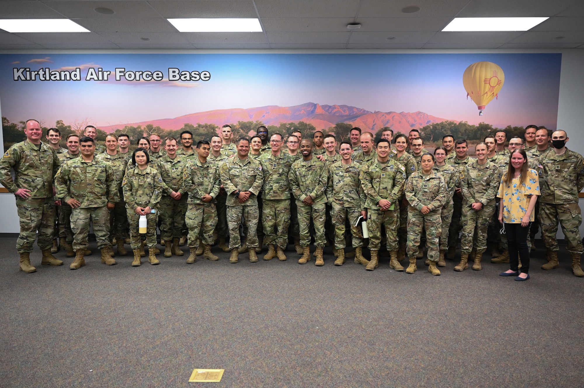 A group of Airmen and Guardians pose for a photo.