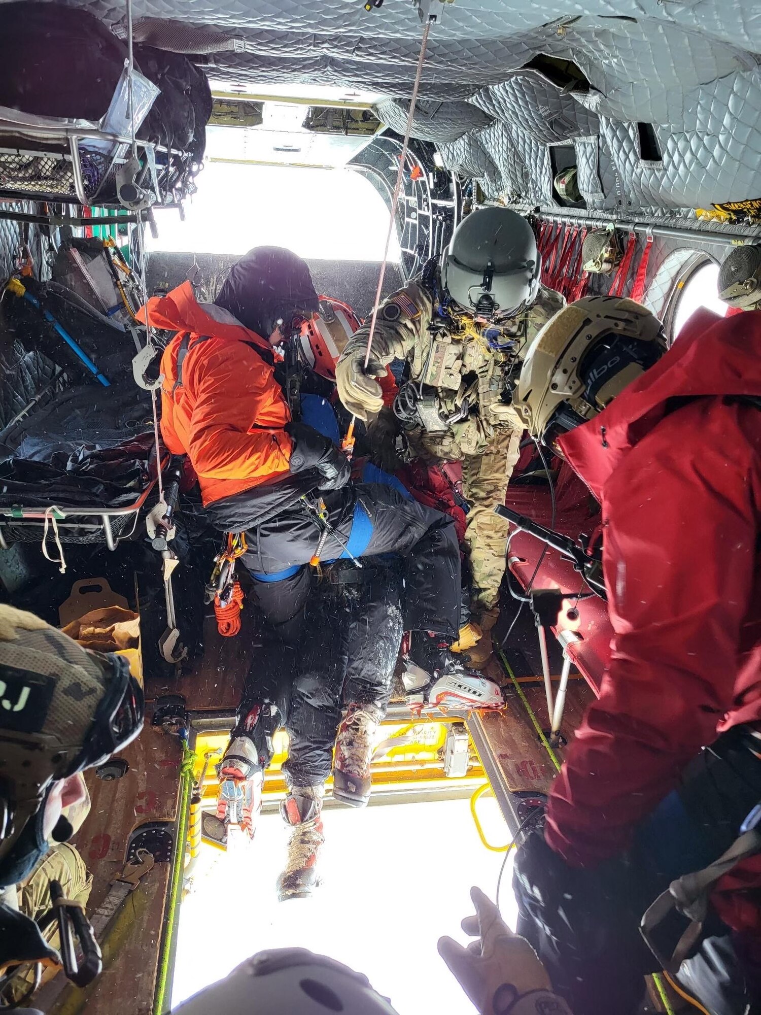 304th Rescue Squadron pararescuemen lift an injured climber into a CH-47 Chinook helicopter May 13, 2022 on Mount Rainier, Washington. The 304th RQS was called on to assist the National Park Service with rescuing two stranded climbers from the mountain. (Courtesy photo)