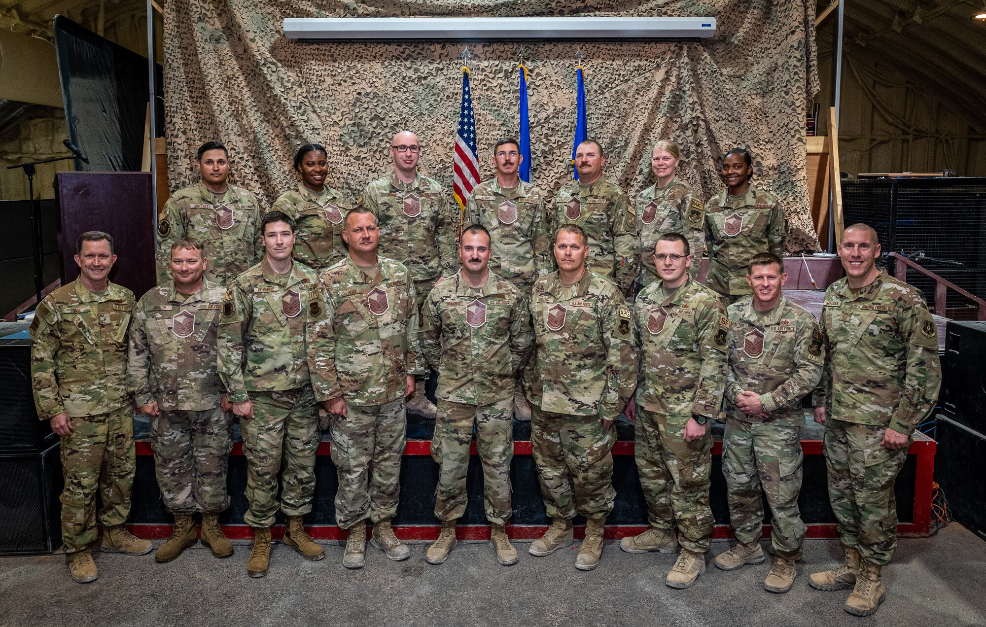 Leadership from the 332d Air Expeditionary Wing stand alongside Red Tail's newest master sergeant selects during a promotion release party at an undisclosed location in Southwest Asia, June 1, 2022. This year, the active duty Air Force selected 4,040 of 27,296 eligible technical sergeants for the promotion to master sergeant, at a selection rate of 14.8%. (U.S. Air Force photo by Master Sgt. Christopher Parr)
