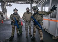An Italian sailor discusses an exercise scenario with a U.S. Coast Guardsman, assigned to the Tactical Law Enforcement Team South, while conducting a visit, board, search and seizure drill aboard the Lewis B. Puller-class expeditionary sea base USS Hershel "Woody" Williams (ESB 4) as part of exercise Phoenix Express 22, May 30, 2022. Phoenix Express 22, conducted by U.S. Naval Forces Africa, is a maritime exercise designed to improve cooperation among participating nations in order to increase maritime safety and security in the Mediterranean.