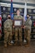 soldier poses with award