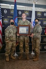 soldier poses with award