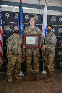 soldier poses with award