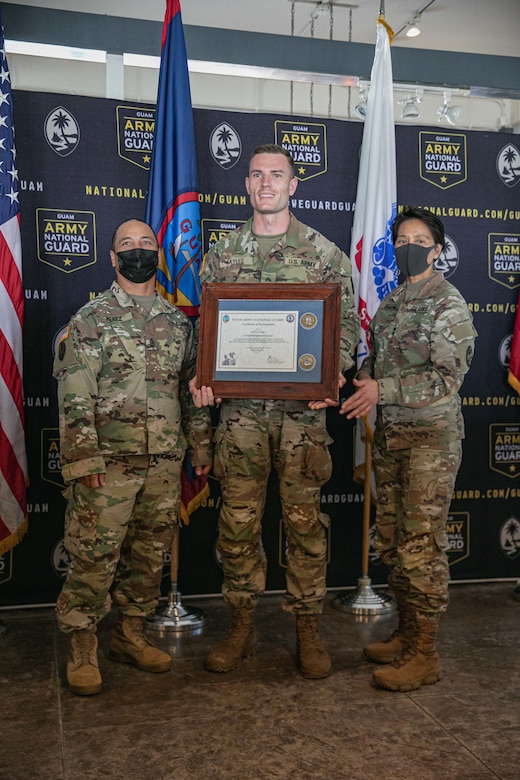 soldier poses with award