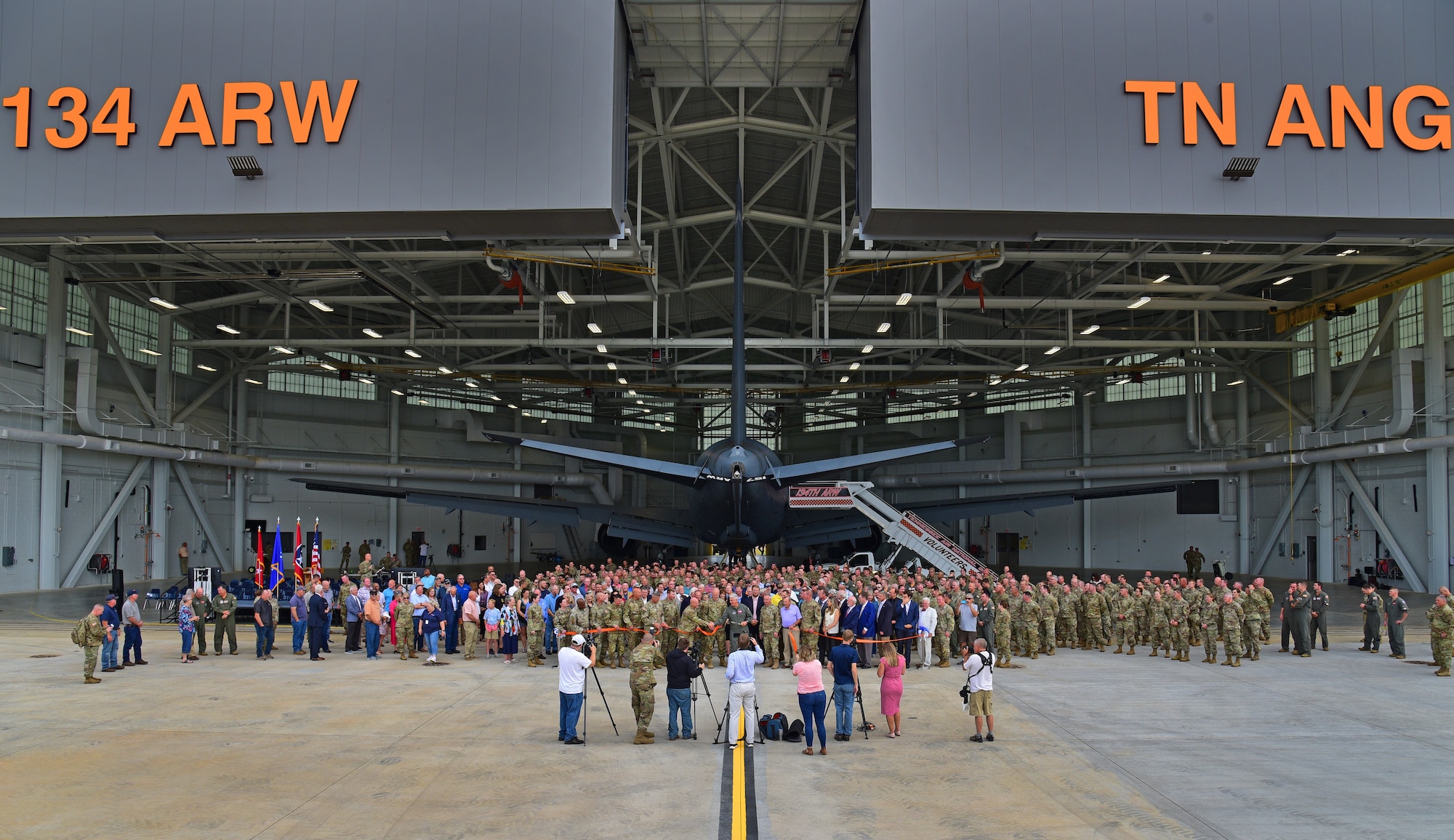 Leaders of the Tennessee National Guard, 134th Air Refueling Wing, civic leaders and construction teams line up to cut the ceremonial ribbon as part of a ribbon cutting ceremony in a newly constructed hanger on McGhee Tyson Air National Guard Base, Tennessee, June 2, 2022. The new hangar will house the units KC-135 Stratotankers and can also accommodate larger aircraft such as the KC-46 Pegasus. U.S. Air National Guard photo by Senior Master Sgt. Kendra Owenby.