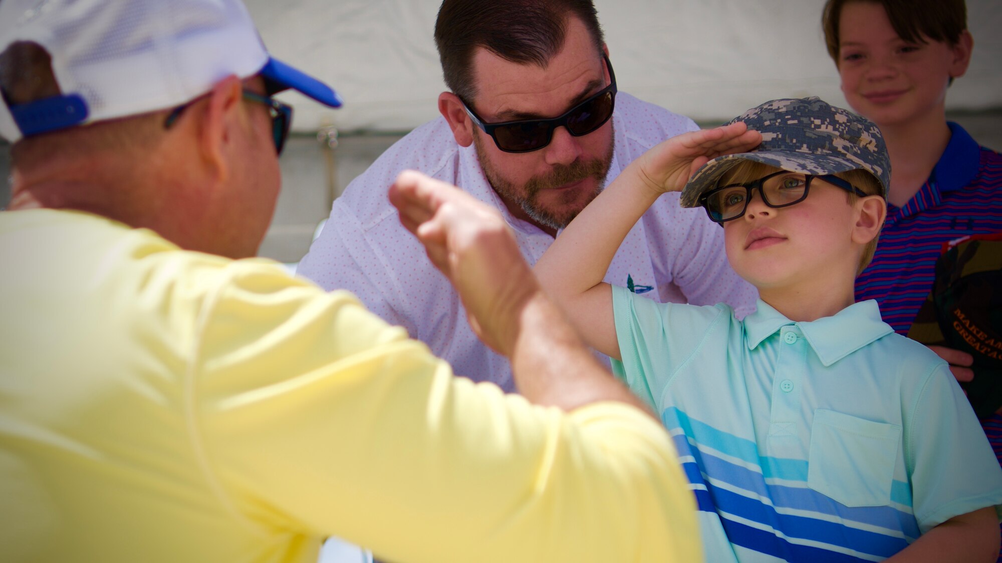 U.S. Air Force Col. Kurt Matthews, 927th Air Refueling Wing commander and Lennon Little share a salute on MacDill AFB, Fla., April 30, 2022. Matthews presented the commander’s coin to Little and named him Honorary Commander for the day in front of the 927th ARW in recognition for his bravery and resilience in the face of health challenges. (U.S. Air Force photo by Tech Sgt. Brad Tipton)