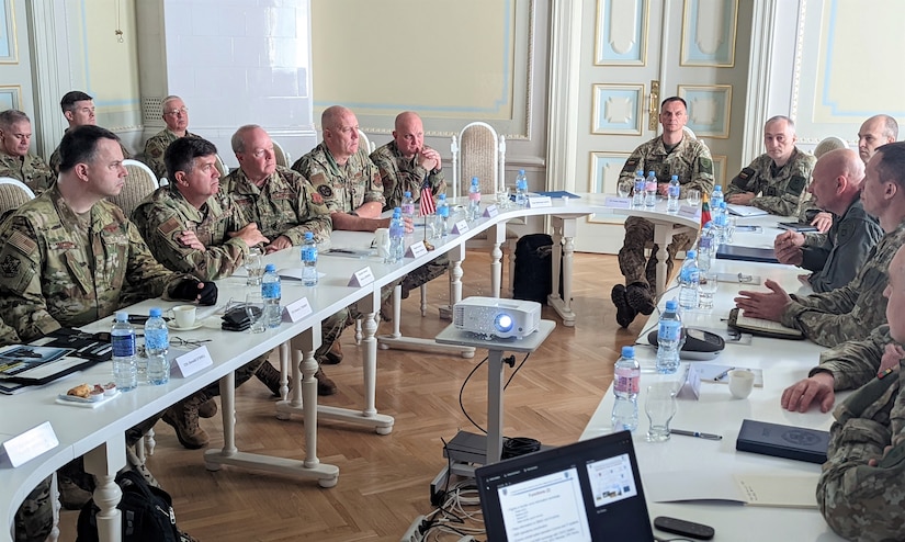 Brig. Gen. Michael Regan Jr., deputy adjutant general-Air, and and other Pennsylvania Air National Guard senior leaders and senior leaders from the Lithuanian Air Force discuss previous and future State Partnership Program engagements on May 23, 2022, at Lithuanian Air Force headquarters in Kaunas, Lithuania.