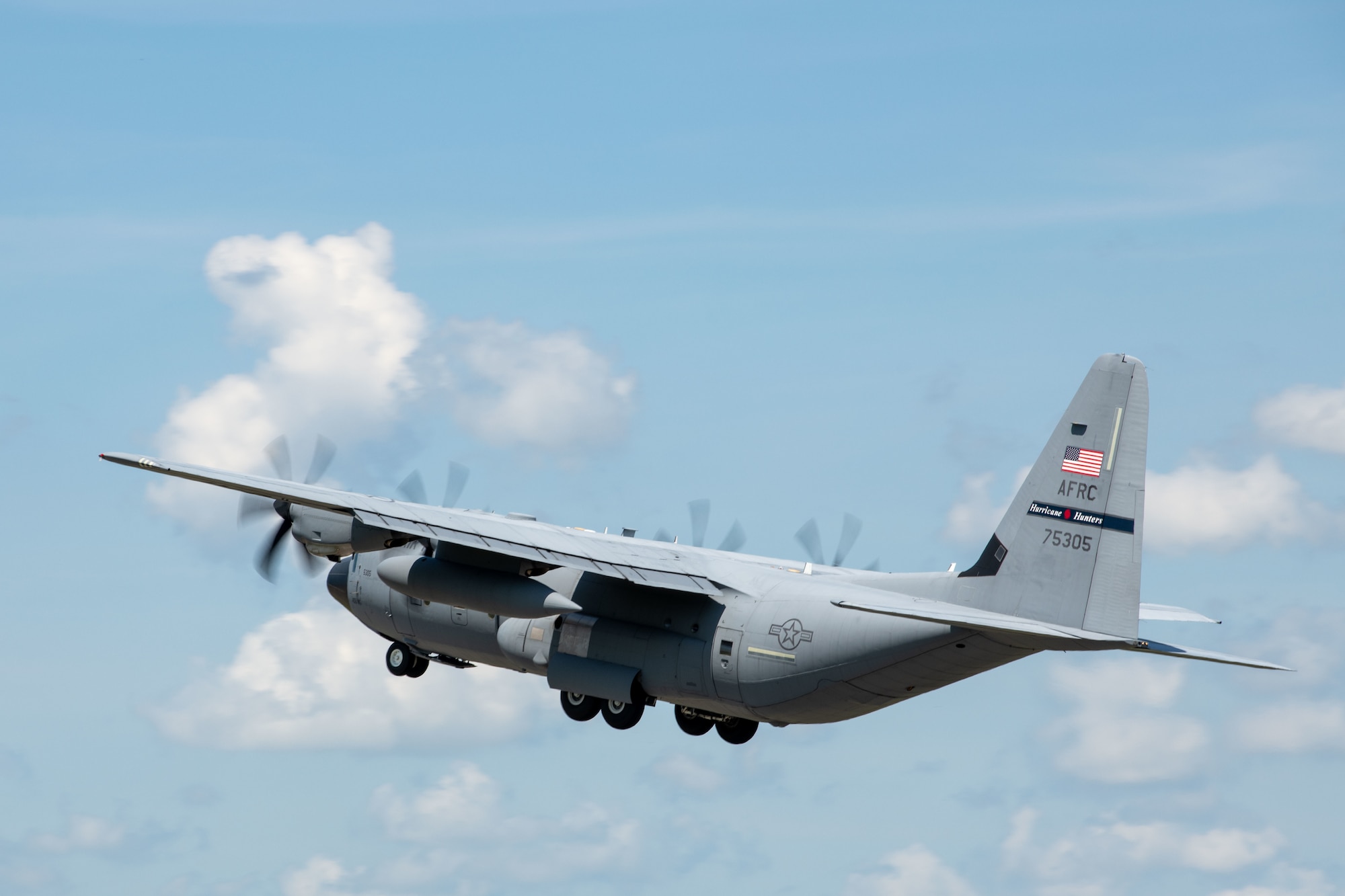 A WC-130J  ascends after take off