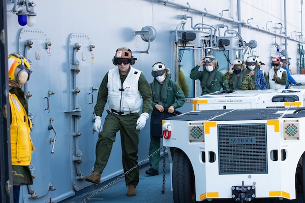 220603-N-CM110-1082 PACIFIC OCEAN, Japan (June 3, 2022) – Members of Japan Self-Defense Force transit the flight deck aboard amphibious assault carrier USS Tripoli (LHA 7), June 3, 2022. Tripoli is conducting routine operations in U.S. 7th Fleet. (U.S. Navy photo by Mass Communication Specialist 3rd Class Maci Sternod)