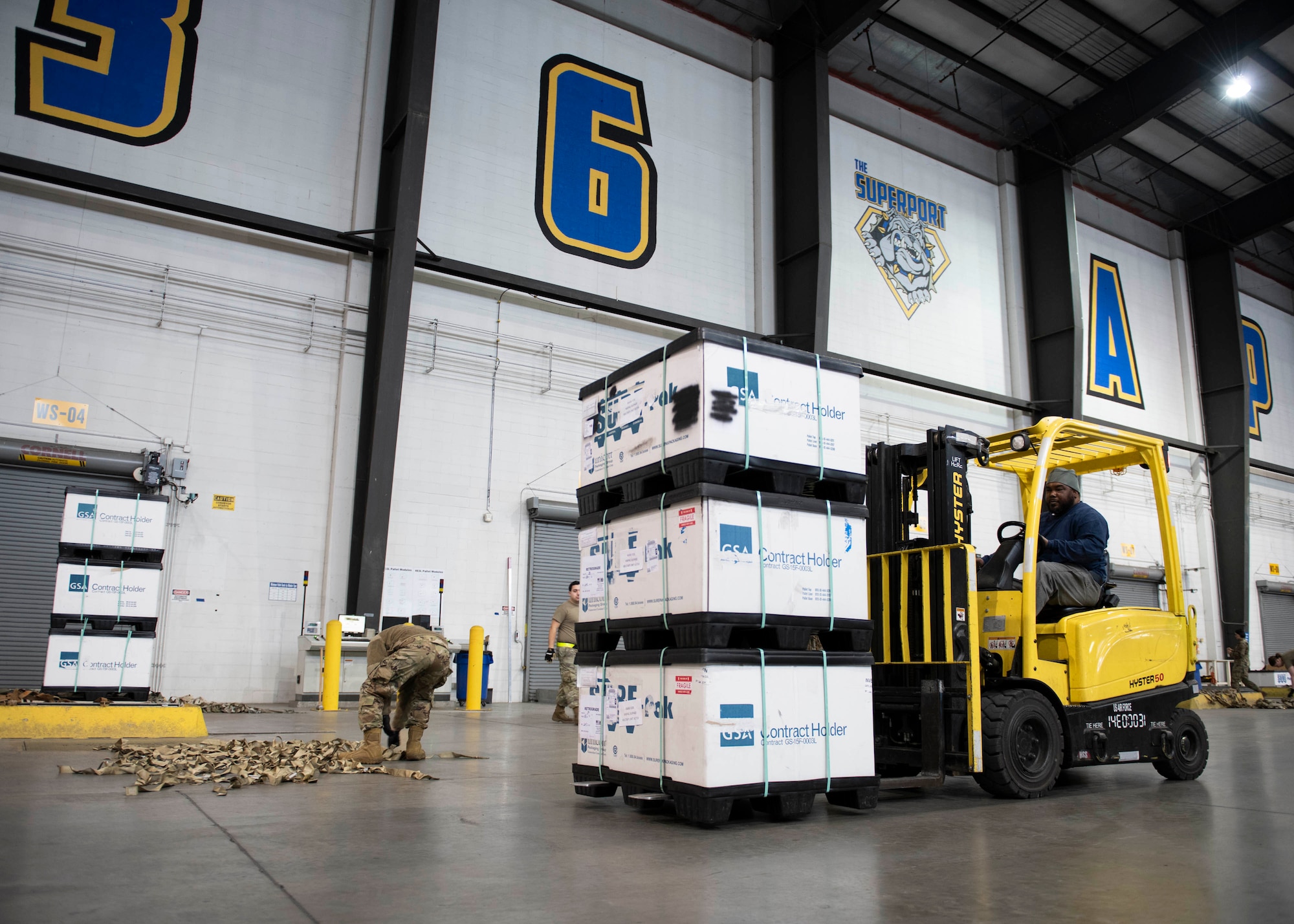 Charles Knight, 436th Aerial Port Squadron materials handler, uses a forklift to move packages of body armor and helmets bound for Ukraine during a foreign mili-tary sales mission at Dover Air Force Base, Delaware, March 8, 2022. Since 2014, the United States has committed more than $5.4 billion in total assistance to Ukraine, including security and non-security assistance. The Unit-ed States reaffirms its steadfast commitment to Ukraine’s sover-eignty and territorial integrity in support of a secure and prosper-ous Ukraine. (U.S. Air Force pho-to by Tech. Sgt. J.D. Strong II)