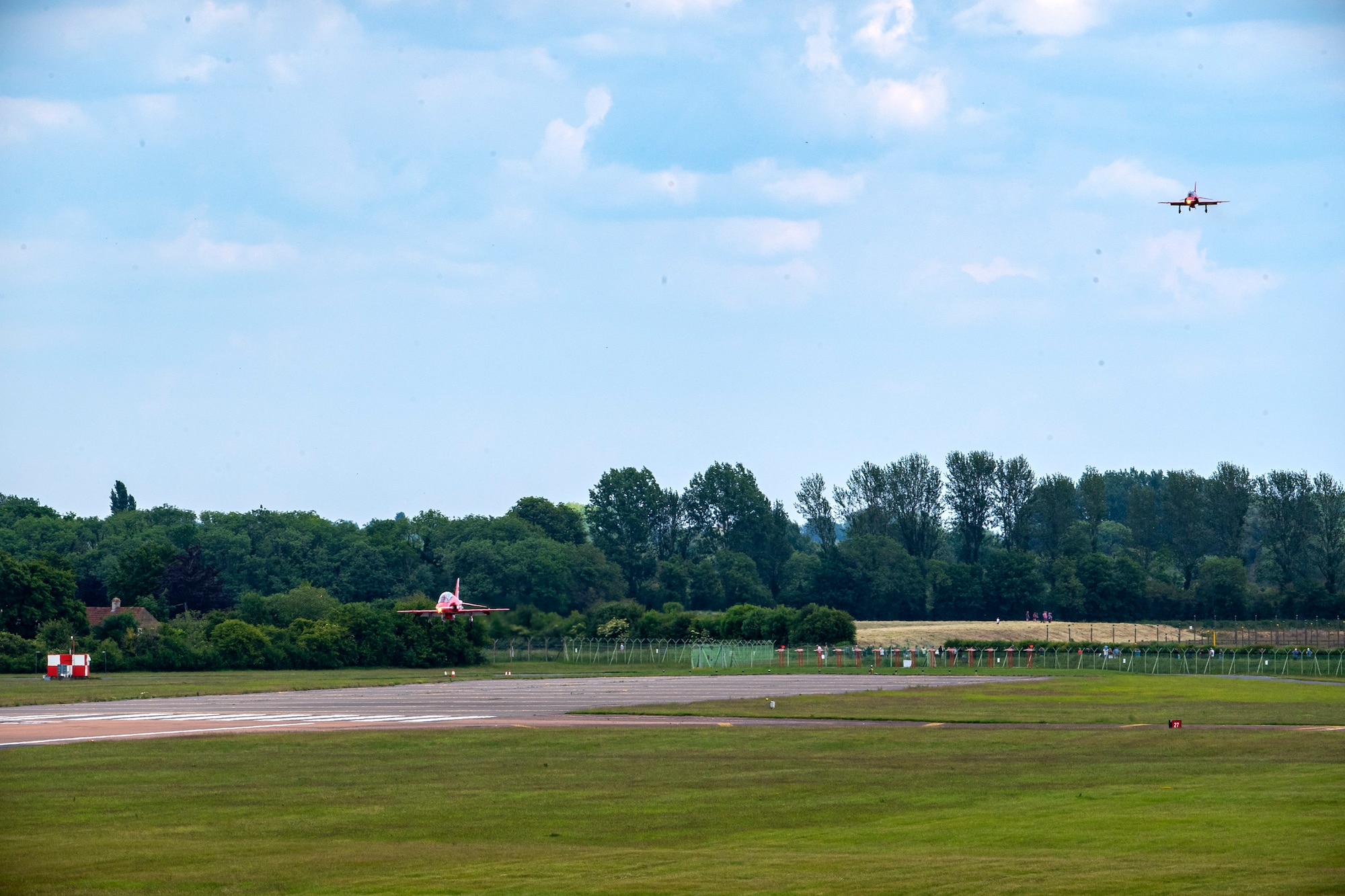 Hawk T1 aircraft assigned to the Royal Air Force aerobatic team, known as the Red Arrows, prepare to land at RAF Fairford, England, June 2, 2022. The Red Arrows landed at Fairford to refuel in preparation for the Queen’s Platinum Jubilee Ceremonies and Midlands Air Festival. (U.S. Air Force photo by Staff Sgt. Eugene Oliver)